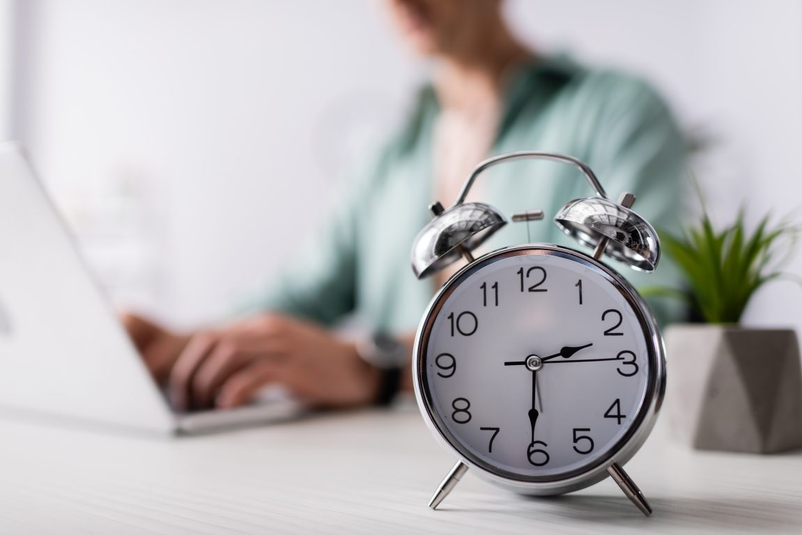 Alarm clock with person in the background