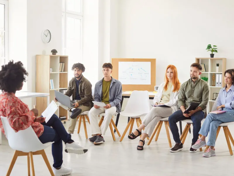 A group of people attending sexual harassment training course.